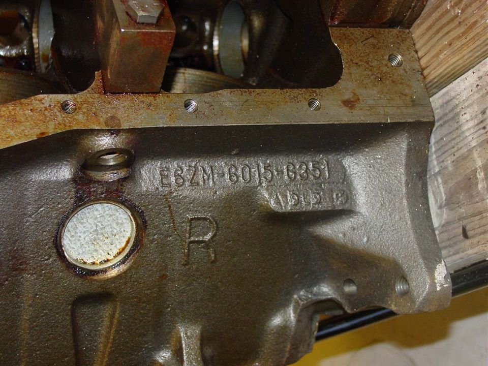 Close-up of an engine block casting with part numbers E6ZM-6015-B351 visible