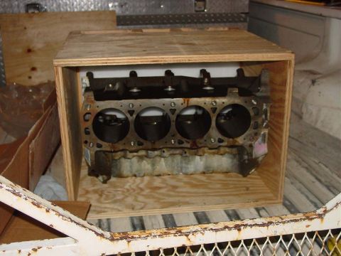 1971 Ford Mustang - A disassembled engine block is secured within a wooden crate, likely being transported.