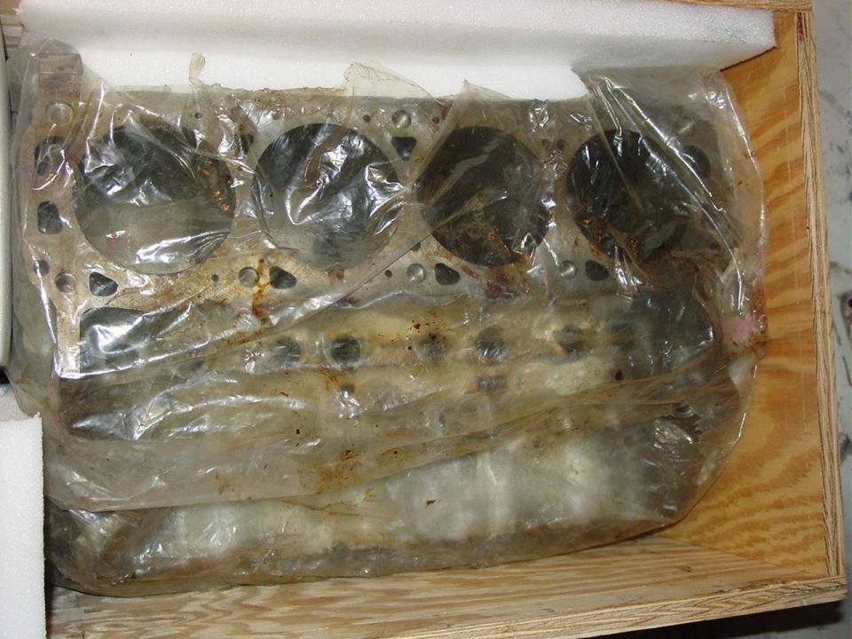 Engine block in plastic wrap inside a wooden crate