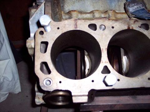 1971 Ford Mustang - Close-up of an engine block, revealing cylinder bores and a NASCAR-branded strap. No year identification is visible.