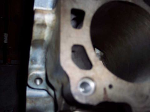 1971 Ford Mustang - Close-up view of an engine cylinder head, showing a large bore opening and internal passages.