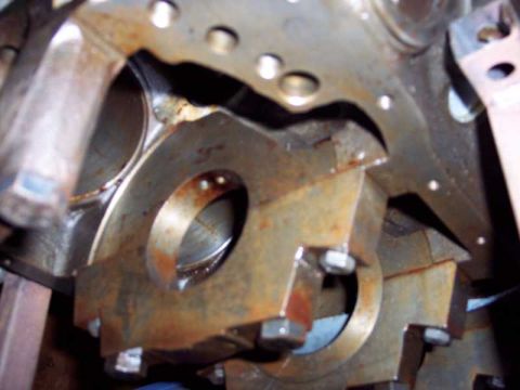 1971 Ford Mustang - Close-up of an engine block's main bearing cap area, showing rust and bolts.