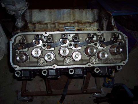 1971 Ford Mustang - Close-up of an engine cylinder head, showing internal components like rocker arms and valves.