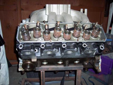 1971 Ford Mustang - Close-up view of an engine's intake manifold and cylinder head, likely undergoing assembly or repair.