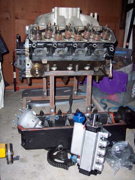1971 Ford Mustang - Engine components, including a Ford V8 block and intake, are laid out on a concrete floor.