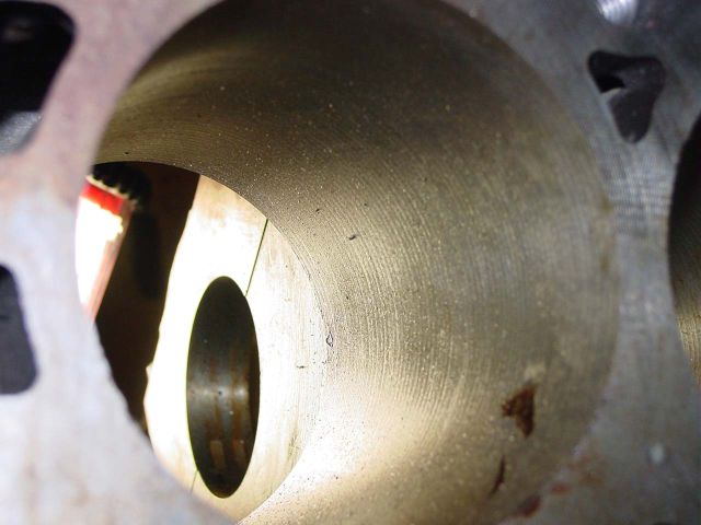 Close-up view inside an engine cylinder bore with visible honing marks