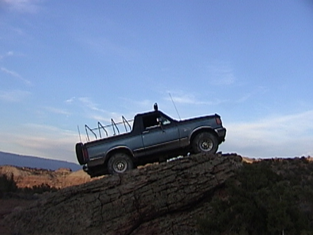 Blue 1991 Ford Bronco on rocky terrain