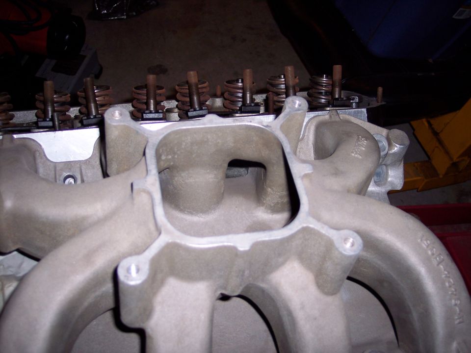Close-up of an engine intake manifold with valve springs and pushrods visible