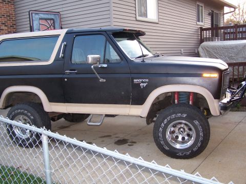 1986 Ford Bronco - This 1986 Ford Bronco features a two-tone paint scheme and visible aftermarket modifications to its suspension and wheels.