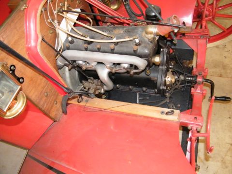 1909 Ford Model T - The engine bay of a vintage car, its mechanical components and wooden interior accents.