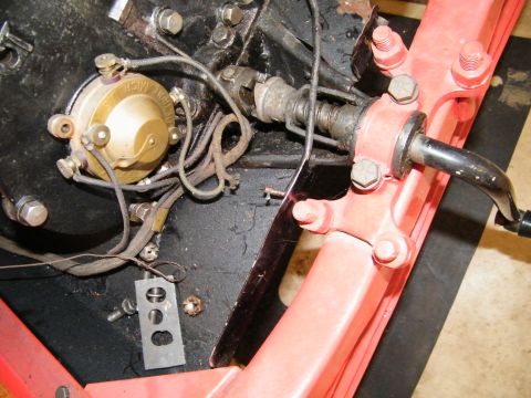 1909 Ford Model T - Detail of an engine component, possibly a magneto, with visible wiring and part of the chassis.
