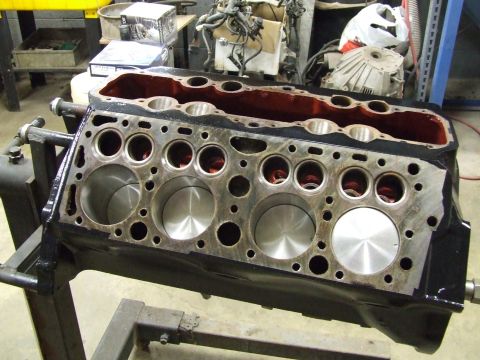 1967 Ford Bronco - Engine block on a stand, viewed from the side, with cylinders and internal components visible.