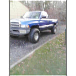 1995 Dodge 1500 - A blue 1995 Dodge 1500 pickup truck is shown from a 3q-front angle.