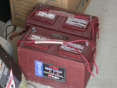 1994 Ford Bronco - Two Trojan deep cycle batteries are shown stacked, secured with red rope handles.