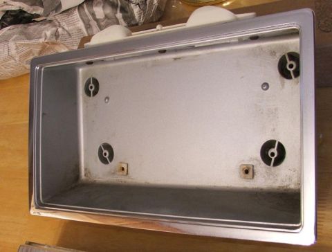 1989 Ford Bronco II - This is a close-up view of an interior vehicle part, possibly a trim piece or housing, with visible mounting points and a chrome-finished e…