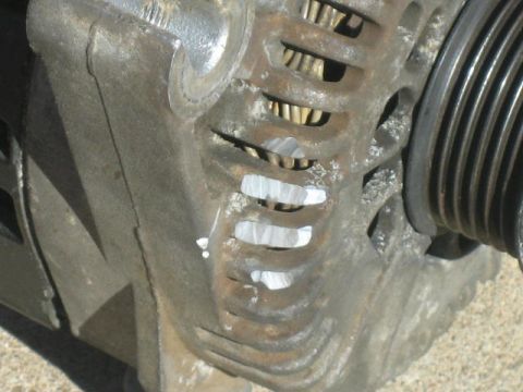 1996 Ford Thunderbird - This photo shows a close-up of a vehicle's alternator, a component of the electrical system.