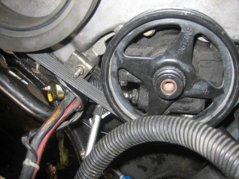 1996 Ford Thunderbird - A close-up view of an engine pulley with visible part numbers, suggesting it is a component within a larger system.