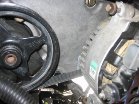 1996 Ford Thunderbird - Alternator and power steering pulley assembly with serpentine belt visible.
