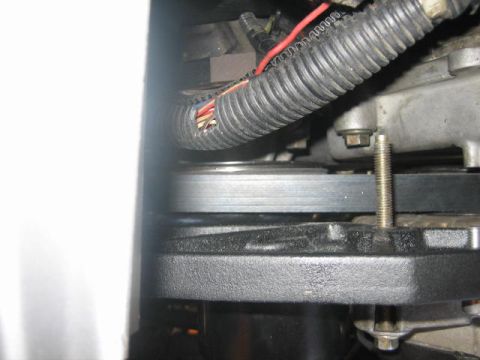 1996 Ford Thunderbird - Close-up view of an engine's belt and pulley system, showing mechanical components and wiring.