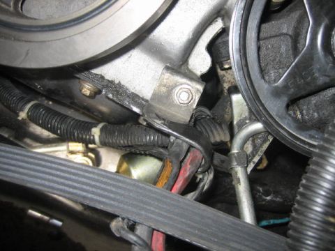 1996 Ford Thunderbird - A close-up view of engine components including belts and pulleys.