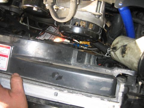 1996 Ford Thunderbird - Close-up view of engine bay components, including an alternator and radiator cover.