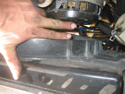 1996 Ford Thunderbird - Close-up of a hand near the alternator and fan shroud, with Supermotors.net logo visible.