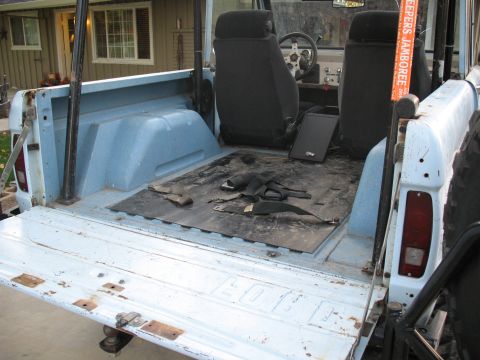 1976 Ford Bronco - Interior and bed view of a 1976 Ford Bronco, showing the light blue paint and worn flooring.