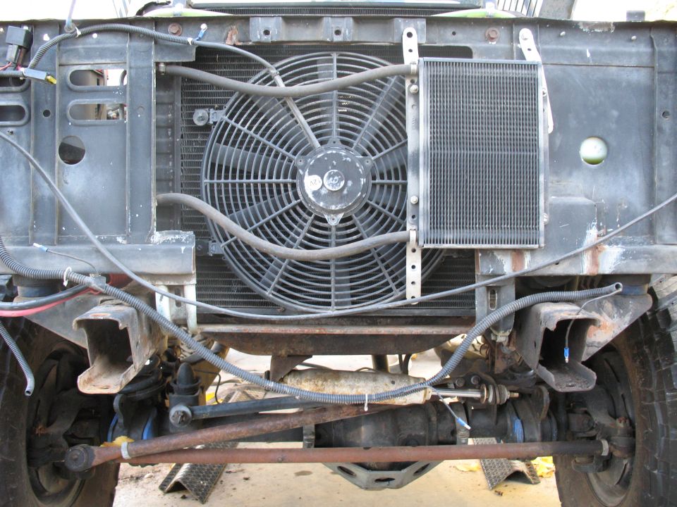 1976 Ford Bronco front end showing radiator, large fan, and suspension components