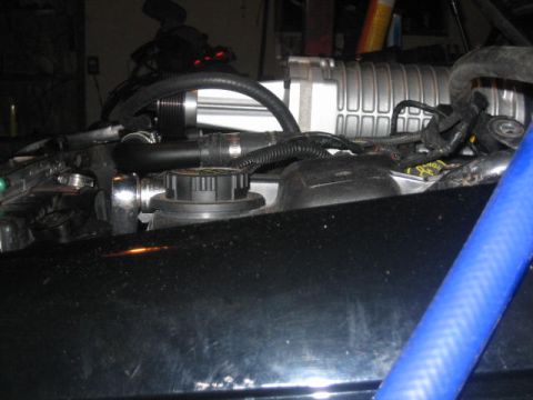 1996 Ford Thunderbird - Close-up view of an engine bay, highlighting a supercharger and associated components.