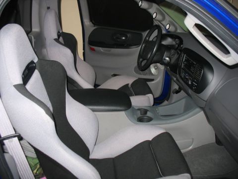 2007 Ford Mustang - Custom truck interior features racing seats and a center console with cup holders.