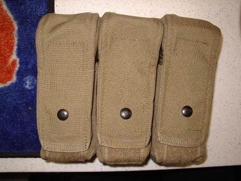 1985 Ford Bronco - Three tan pouches with snaps are displayed on a textured surface next to a blue and orange patterned item.