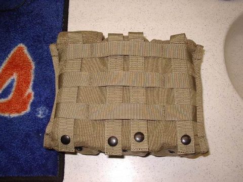 1985 Ford Bronco - A tan tactical pouch with MOLLE webbing and snap closures is shown.