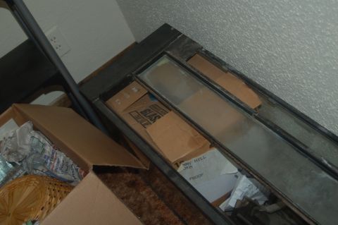 1991 Ford Probe - A collection of boxes and glass panes are stored in a room, with some items in cardboard boxes.