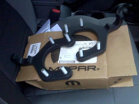 2008 Jeep Wrangler - Two Mopar brackets are shown resting on a Mopar branded box, likely inside a vehicle's cabin.