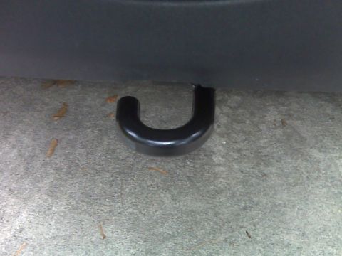 2008 Jeep Wrangler - Close-up of a black tow hook on a vehicle, seen from a low angle against a concrete surface.