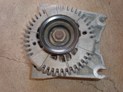 2007 Ford Mustang - Close-up of an automotive alternator with its pulley visible.