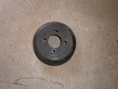 2007 Ford Mustang - A single pulley part is shown against a concrete background.