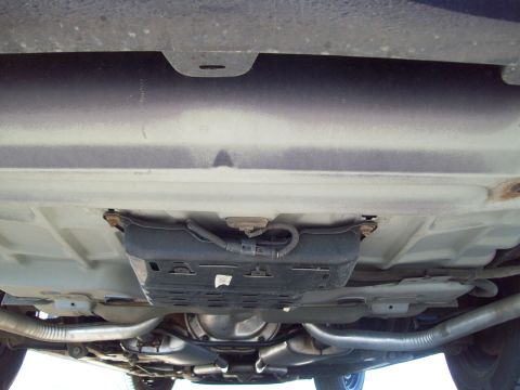 1999 Mercury Grand Marquis - Underside view of a 1999 Mercury Grand Marquis, highlighting its dual exhaust system and rear differential.