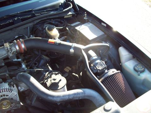 1999 Mercury Grand Marquis - The engine bay features a K&N air intake system with a prominent red and black filter.