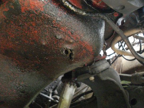 1984 Jeep J-10 - A damaged engine part, possibly from a Jeep J-10, shows signs of wear and tear.