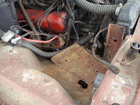 1984 Jeep J-10 - The engine bay shows significant rust and wear on its components, with a visible watermark at the bottom right.