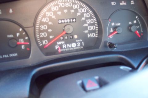 2001 Ford Crown Victoria - Close-up of a car's instrument cluster showing various gauges and the odometer reading.