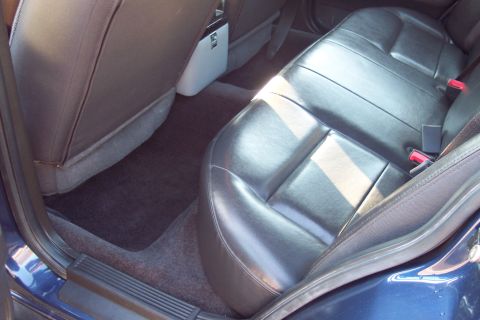 2001 Ford Crown Victoria - The interior of a car is shown, focusing on the rear seats and floor mats.