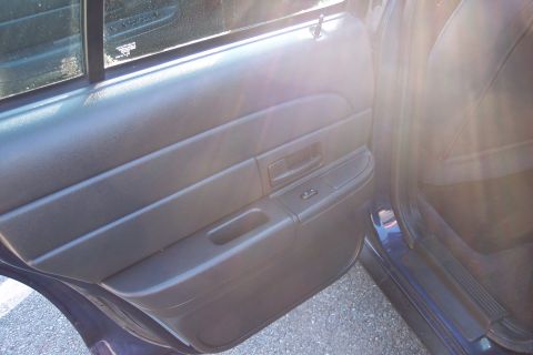 2001 Ford Crown Victoria - Close-up of the interior door panel, showing the window controls and door handle.