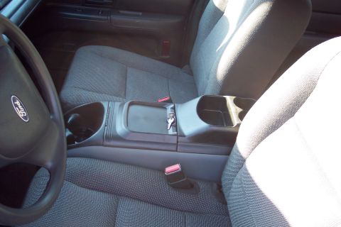 2001 Ford Crown Victoria - Interior view of a 2001 Ford Crown Victoria, highlighting the front seating area and center console.