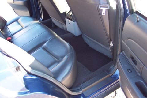 2001 Ford Crown Victoria - The interior of a blue 2001 Ford Crown Victoria, viewed from the rear passenger side.