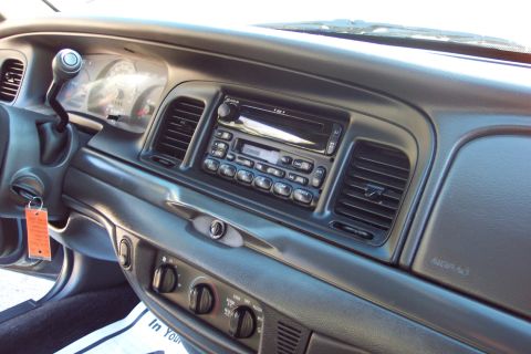 2001 Ford Crown Victoria - The interior of a 2001 Ford Crown Victoria, the dashboard with the radio and climate controls.