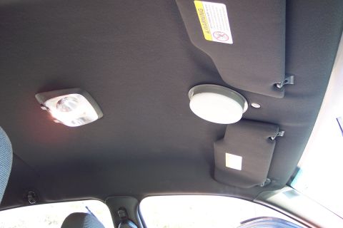 2001 Ford Crown Victoria - The interior ceiling of a 2001 Ford Crown Victoria shows two dome lights and sun visors.