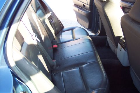 2001 Ford Crown Victoria - Interior view of the back seat and door panel of a vehicle.
