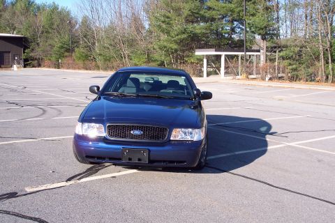 2001 Ford Crown Victoria - Front view of a blue 2001 Ford Crown Victoria in a parking lot.